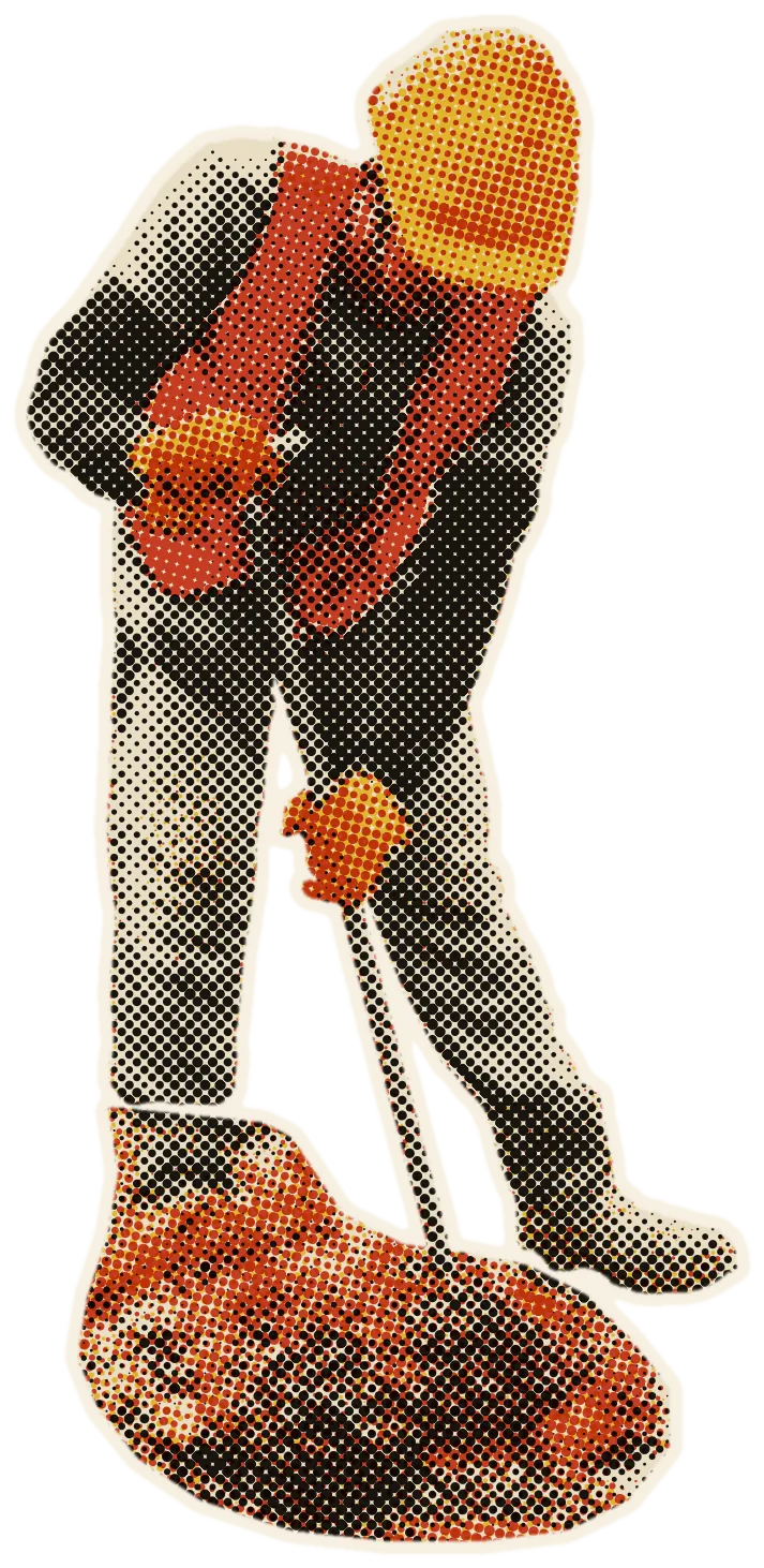 A worker in a hard hat and safety vest moves fruit bunches with a long pole